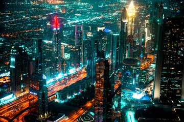 Naklejka na ściany i meble Dubai city at night, view with lit up skyscrapers and roads. 