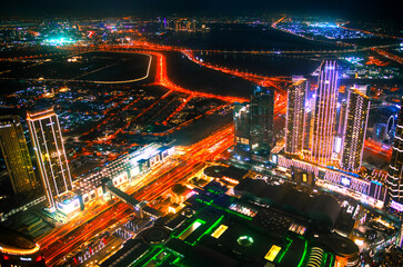 Fototapeta na wymiar Dubai city at night, view with lit up skyscrapers and roads. UAE, 2022