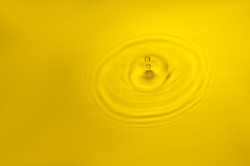 Golden water ripple and water drop.
