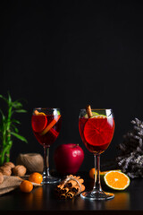 Homemade red wine sangria in wine glasses with slices of fruit, selective focus. Still life