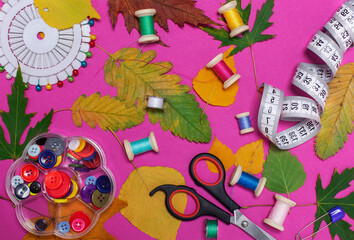 sewing kit of colored threads on a bright autumn background