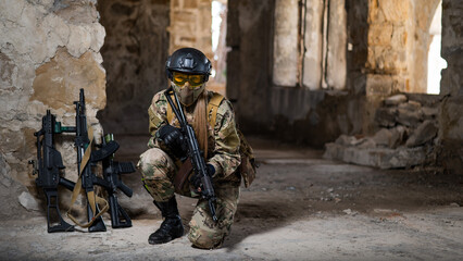 A woman in an army uniform sits in an abandoned building and holds a firearm.