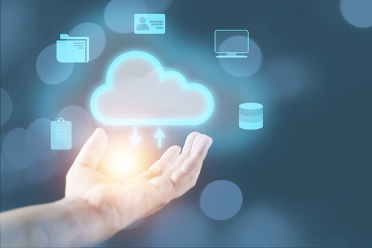 cloud computing concept man's hand holding a virtual image cloud storage which is a form of digital computer data storage That helps facilitate both small and large organizations as well