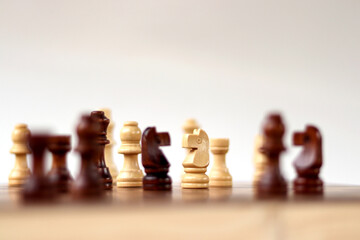 A chessboard with walking figures placed on a white background. Strategy game.