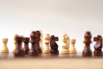 A chessboard with walking figures placed on a white background. Strategy game.