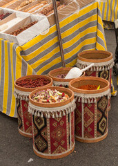 Fruit tea in barrels on the market. A typical kiosk with traditional drinks at the food market