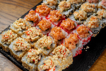 Japanese national dish of sushi, rolls with red fish and salmon chips