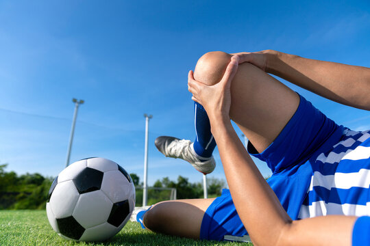 football soccer player accident knee injury sport treatment on champion league final match competition with ball on grass in stadium