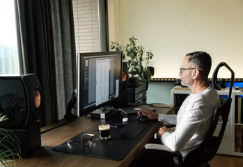 Middle age man working on computer at home.
