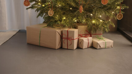 christmas gifts under spruce indoor with warm light