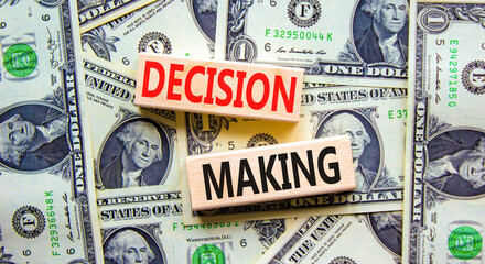 Decision making symbol. Concept words Decision making on wooden blocks. Beautiful background from dollar bills. Business and decision making concept. Copy space.