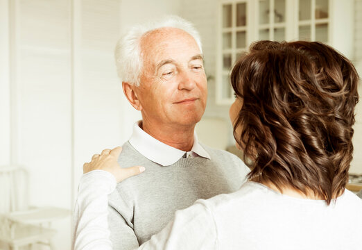 Carefree Happy Active Old Senior Couple Dancing In Kitchen