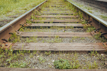 Old, abandoned railroad with wooden sleepers.