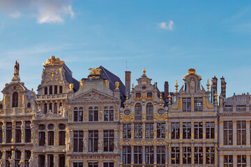 Fototapeta na wymiar Abstract urban or vintage background featuring details of architecture and roofs of medieval buildings at sunset at Grand Place in Brussels Belgium. 