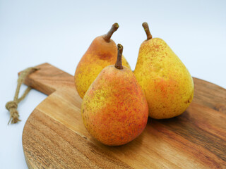 Spotted autumn pears on  a wood cutting board