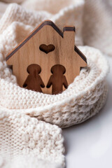 A house wrapped in a scarf. Winter. Home insulation, protection from cold and bad weather, room...