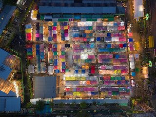 Aerial top view of Night Market people walking street, Colorful tents in the train of Ratchada at Bangkok city, Thailand. Rerail shops