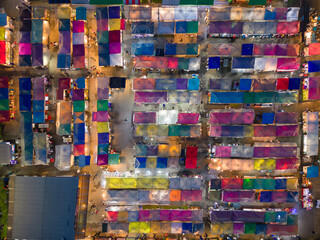Aerial top view of Night Market people walking street, Colorful tents in the train of Ratchada at Bangkok city, Thailand. Rerail shops