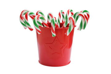 A lot of twisted candy canes of white-green-red color in a red bucket isolated on white