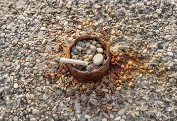 Cigarette butts combined in a cigarette disc. Concept of many cigarette debris after smoking. Nicotine addiction. Garbage