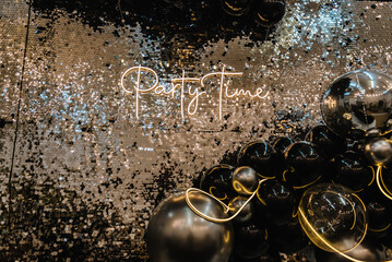 Text party time. Happy New Year 2023. Photo booth was decorated black and silver balloons and led...