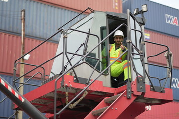 Dock worker man in safety vest work in container port terminal. male Industrial Engineer in Hard...