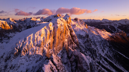 sunset in the mountains covered by snow