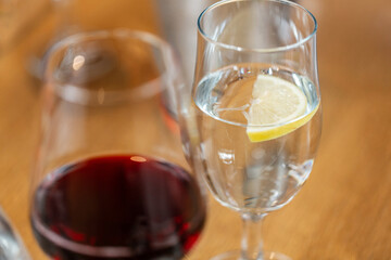 drinks concept - close up of glass water with lemon at restaurant