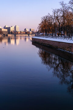 Winter cityscape - Oder River in Wrocław, promenade and  urban skyline in background in late afternoon sunlight