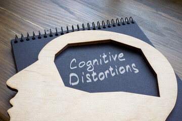 Cognitive distortions handwritten on a page and head.