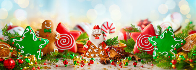 Christmas composition with Christmas handmade gingerbread cookies, winter spices and holidays decorations. Banner.