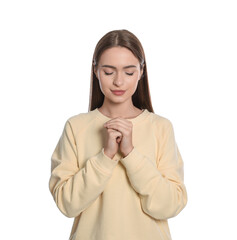 Woman with clasped hands praying on white background