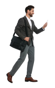 Handsome man with smartphone and black bag walking on white background