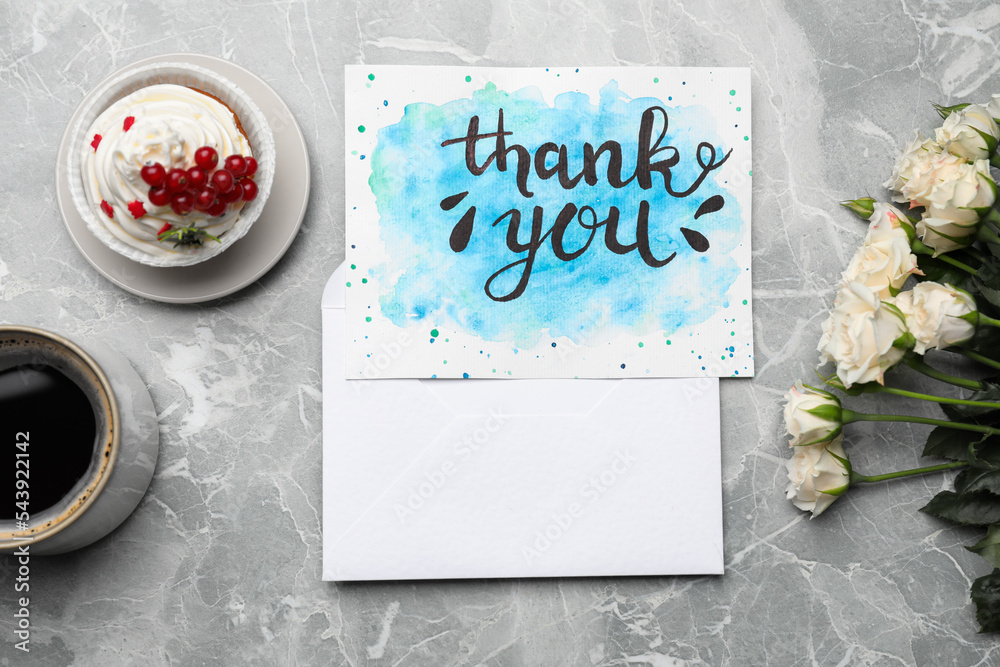 Wall mural Card with phrase Thank you, cup of coffee, cupcake and flowers on light grey marble table, flat lay - Wall murals