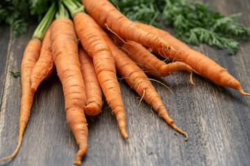 Bunch of carrots on wooden table.