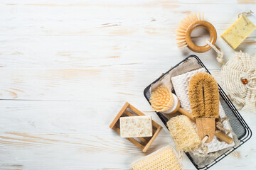 Zero waste cleaning utensils for kitchen at white wooden table. Natural brushes, soap and towel. Plastic free concept. Reusable, sustainability, eco-friendly. Flat lay image.