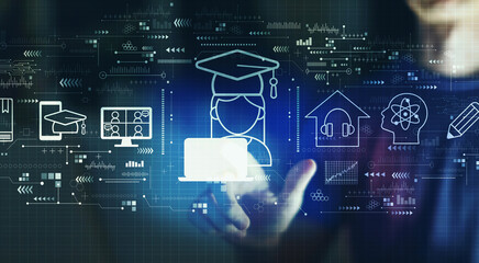 Fototapeta premium Distance learning theme with young man touching a digital screen at night