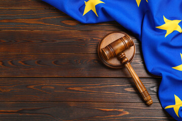 Judge's gavel and flag of European Union on wooden table, flat lay. Space for text