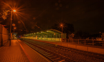 Railway track and train light in night in Prague Podbaba station