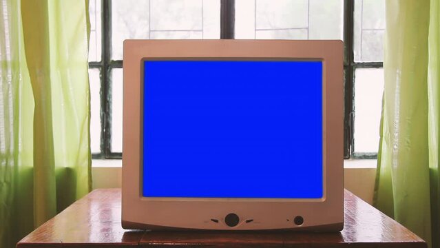 Female Hand Turning On Computer Monitor with Blue Screen. Close Up. 4K Resolution.