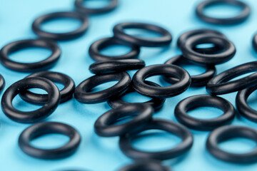 Black sealing rubber gaskets on colored blue background
