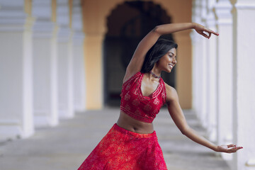 Yogini dancing and practicing yoga near a palace in Mysore, India. Mindful yoga practice....