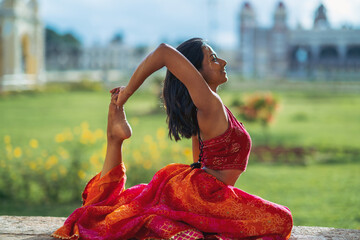 Yogini dancing and practicing yoga near a palace in Mysore, India. Mindful yoga practice....