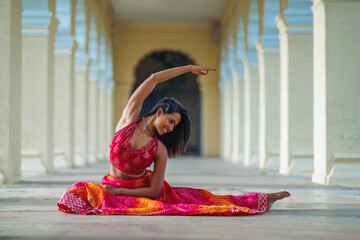 Yogini dancing and practicing yoga near a palace in Mysore, India. Mindful yoga practice....