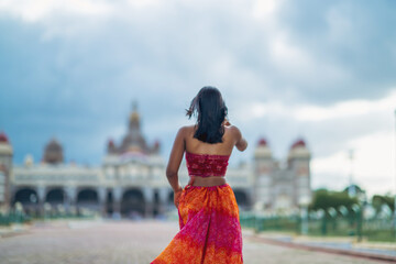 Yogini dancing and practicing yoga near a palace in Mysore, India. Mindful yoga practice. Improvisation. Contemporary dance.