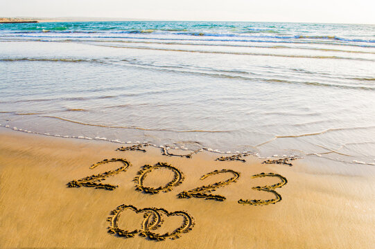 new year 2023 text on beach
