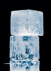 Crystal-clear shiny natural stacked ice cubes on black background.
