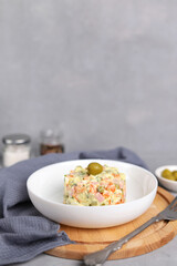 Ensaladilla Rusa in a white plate. Traditional Spanish food is tapas. Selective focus. Copy space. Vertical photo