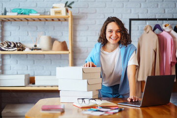 Small business owner, entrepreneur, seller  checking ecommerce clothing store orders  working in...