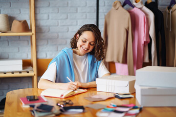 Small business owner, entrepreneur, seller  checking ecommerce clothing store orders  working in her office. Online sales.